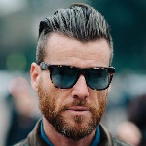 Long slicked back undercut hairstyle with thick beard