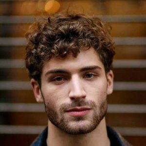 messy curls hairstyle for men medium length haircuts