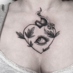 sacred heart tattoo on chest with eye in the middle design