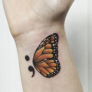 colorful butterfly semicolon tattoo on wrist