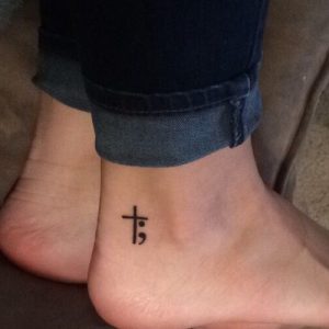 minimal semicolon cross tattoo designs on ankle