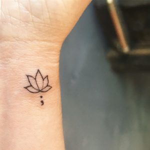 simple flower semicolon tattoo design