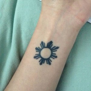 small Filipino Sun Tattoo design on wrist
