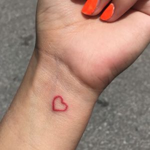 tiny red heart tattoo on wrist design