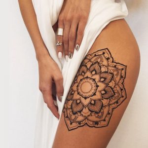 floral pattern flower henna tattoo on leg thigh