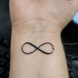 simple infinity semicolon tattoo design on wrist