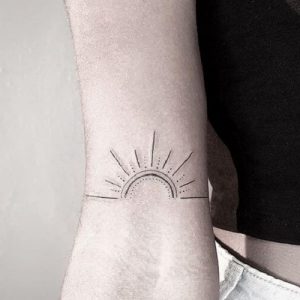 simple small outline Sun Tattoo design on arm