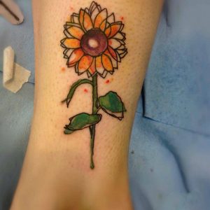 sunflower watercolor tattoo design on wrist